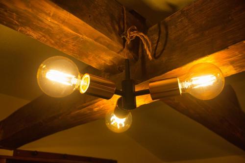 a ceiling fan with lights on a wooden ceiling at Minkago 鹿児島駅前 #KG1 in Kagoshima