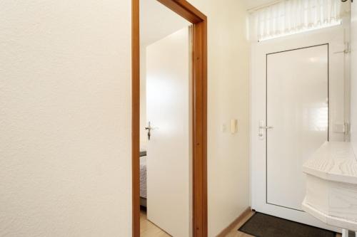 a room with a door and a mirror at Grömitz Center Wohnung 759 in Grömitz