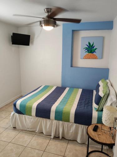 a bedroom with a bed with a blue wall at Short Walk to Beach 1 in South Padre Island