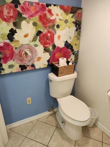 a bathroom with a toilet with a painting on the wall at Short Walk to Beach 1 in South Padre Island