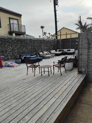 two chairs and a table on a wooden deck at Short Walk to Beach 1 in South Padre Island