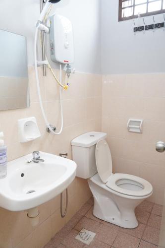 a bathroom with a toilet and a sink at Ir Inn Hotel in Skudai