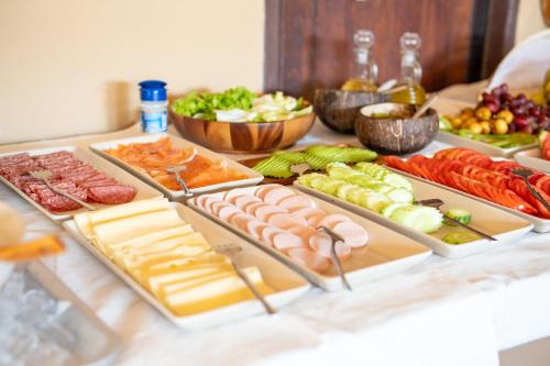 a table topped with different types of meats and vegetables at Lanta Riviera Beach Resort in Ko Lanta