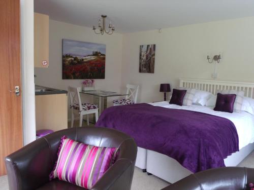 a bedroom with a bed and a table and chairs at Acers Studio in Newark-on-Trent