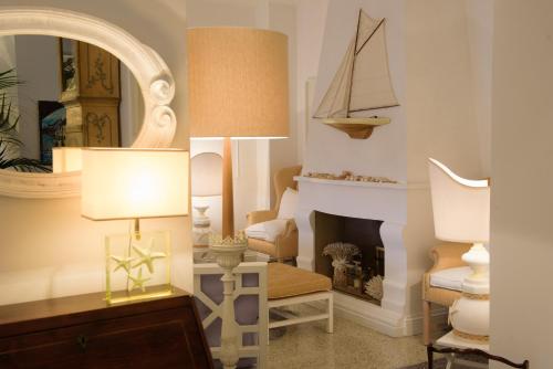 a living room with a lamp and a fireplace at Hotel Helvetia in Sestri Levante