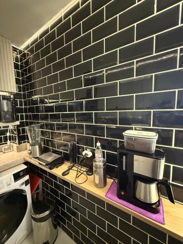 a kitchen with a counter with a coffee maker on a shelf at 2 Dorm Completo Moderno Tecnológico e Decorado in Sao Paulo