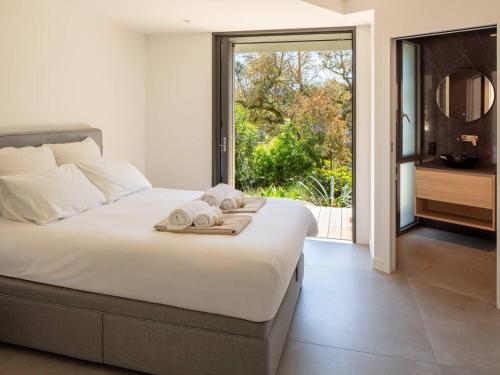 une chambre avec un grand lit avec des serviettes dessus dans l'établissement Villa de Luxe Contemporaine à Hossegor - FR-1-791-39, à Soorts-Hossegor