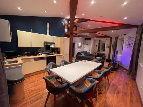 a kitchen and living room with a table and chairs at Appartement moderne au centre d'Épinal, 2-4 pers - FR-1-589-807 in Épinal