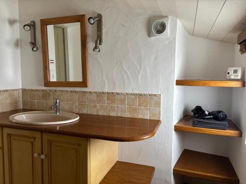 a bathroom with a sink and a mirror at Maison noirmoutrine confortable pour 7 pers avec jardin et parking - FR-1-823-152 in Noirmoutier-en-l'lle