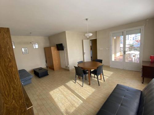 un salon avec une table et des chaises dans une pièce dans l'établissement Appartement lumineux à Canet-Plage, 2 chambres, proche de la plage - FR-1-750-84, à Canet