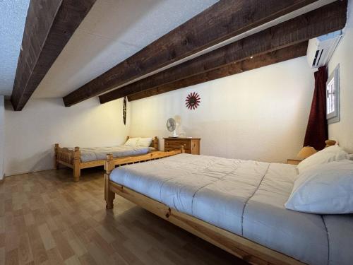 une chambre avec deux lits dans une pièce dans l'établissement T2 Mezzanine près de la plage avec parking au Cap d'Agde - FR-1-749-99, au Cap d'Agde