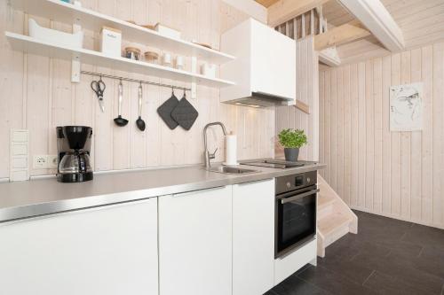 a kitchen with white cabinets and a sink at Twinhus Süssau in Süssau