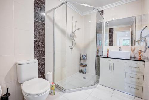 a bathroom with a shower and a toilet and a sink at Lakeview Family Retreat Canberra Cozy Townhouse in Gungahlin