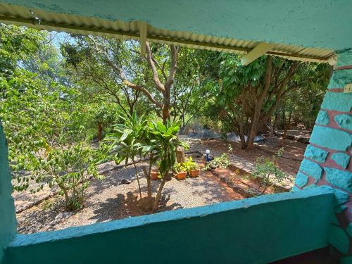 a view from a window of a garden with plants at Captans Stay in Lonavala