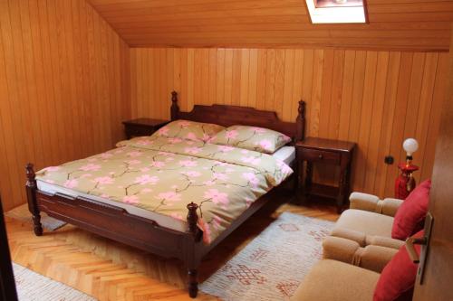 a bedroom with a bed and two chairs at Holiday Home Zbilje in Visoko