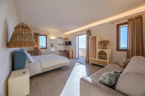 a bedroom with a bed and a living room with a couch at Villa La Bella Vita in Petrosino