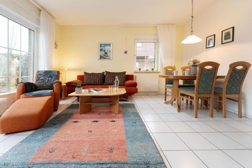 a living room with a couch and a table at Ferienhaus 17a in Kellenhusen