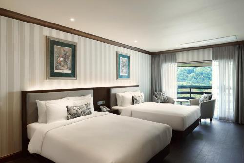 a hotel room with two beds and a window at KensingtonHotel Seorak in Sokcho