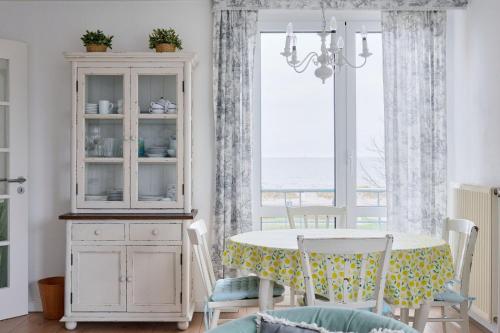 a dining room with a table and a window at Dorfring 36 Albatros in Stein