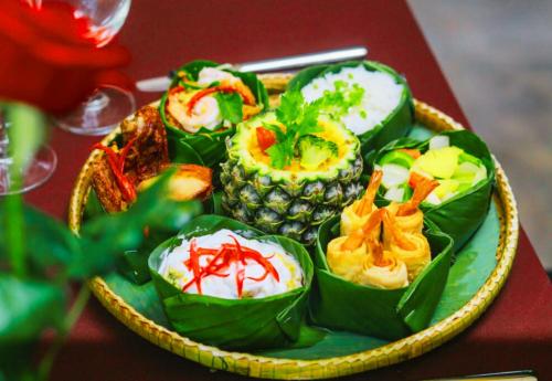 a plate of food with pineapple and other foods on a table at Angkor Home 27 in Phumĭ Réach Born