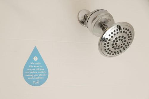 a shower drain with a drop of water next to it at Courtyard by Marriott Springfield Airport in Springfield