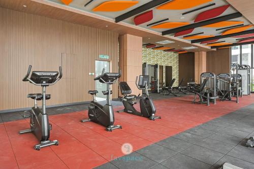 a gym with a row of treadmills and exercise bikes at Jalan Puchong - 3B2B - 7 pax - 7 min to AEON BiG & Train in Puchong
