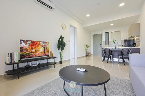 a living room with a couch and a tv and a table at Jalan Puchong - 3B2B - 7 pax - 7 min to AEON BiG & Train in Puchong