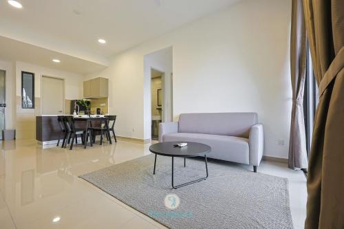 a living room with a couch and a table at Jalan Puchong - 3B2B - 7 pax - 7 min to AEON BiG & Train in Puchong
