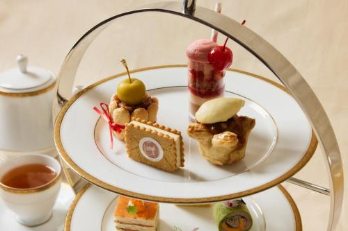 a plate of food on a table with desserts at The Fullerton Hotel Sydney in Sydney