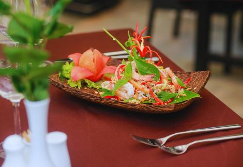 a plate of food on a table with a salad at Angkor Home 27 in Phumĭ Réach Born