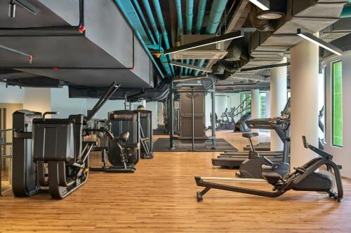 a gym with several treadmills and cardio machines at Renaissance Kuala Lumpur Hotel & Convention Centre in Kuala Lumpur