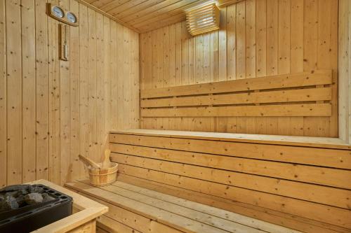 a wooden sauna with a wooden tub in it at Renaissance Kuala Lumpur Hotel & Convention Centre in Kuala Lumpur