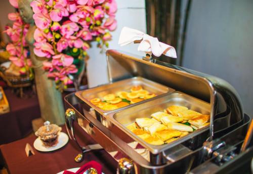 a tray of food sitting on a table with flowers at Angkor Home 27 in Phumĭ Réach Born