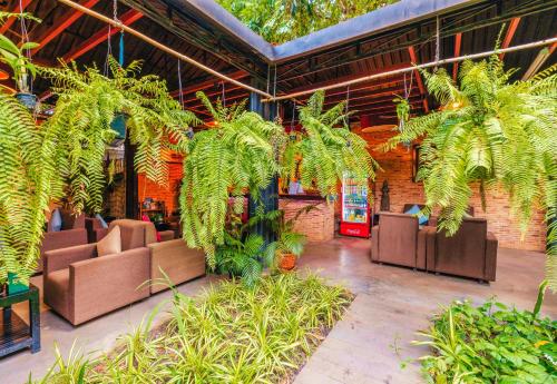 a lobby with chairs and plants in a building at Angkor Home 27 in Phumĭ Réach Born