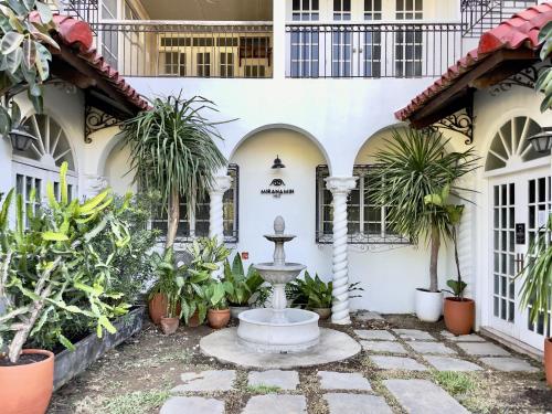 a fountain in the courtyard of a building with plants at MiraNamin Nest CALACHUCHI Room in Unique Historic Home - Balcony, Rooftop, Garden View, Shared Kitchen, Pet Friendly with a Fee in Manila