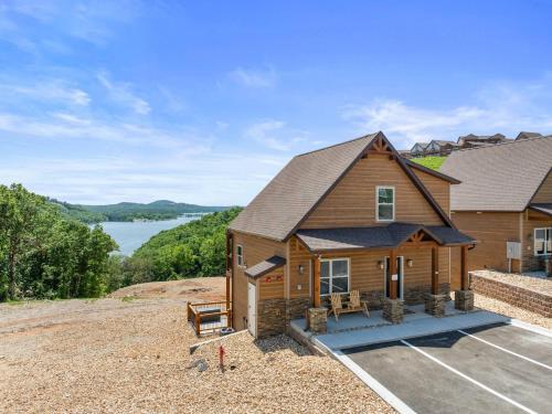 a home with a view of the water at High Cliff Cabin + Private Hot tub at Table Rock Lake in Kimberling City