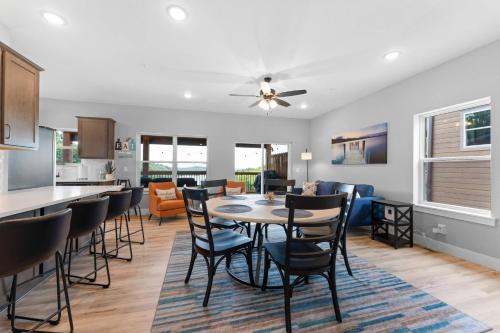 a dining room and living room with a table and chairs at High Cliff Cabin + Private Hot tub at Table Rock Lake in Kimberling City
