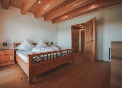 a bedroom with a large bed with a wooden frame at Ferienhaus Kaiser in Aßling