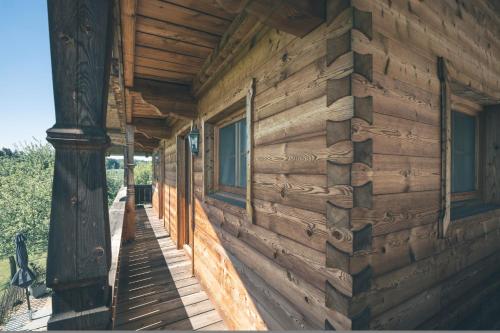 a wooden house with windows on the side of it at Ferienhaus Kaiser in Aßling