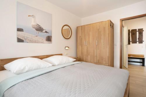 a bedroom with a bed and a bird on the wall at Haus Wiking- Nordstern in Grömitz
