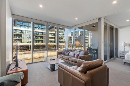 a living room with a couch and a table at Spacious Lakefront Apartment with Pool Access in Kingston