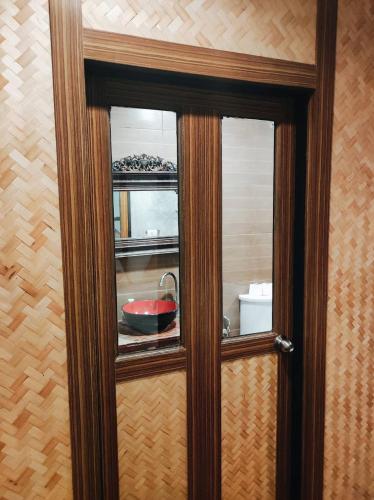 a glass door with a bowl on a counter at mstay in Bangkok