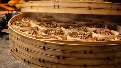 a wooden barrel filled with bowls of food at InterContinental Suzhou Hotel by IHG in Suzhou