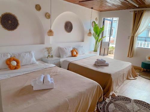 a bedroom with two beds with towels on them at Chút Homestay in Xuan An