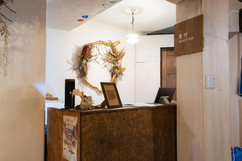 an office with a reception desk with a wreath on the wall at Guest House Waya in Sapporo