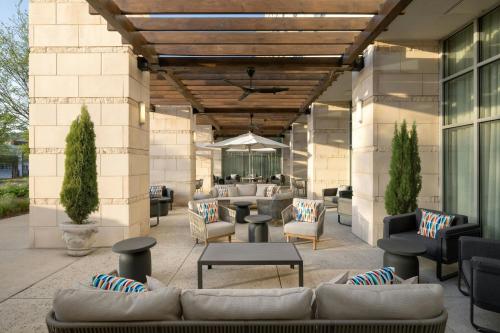 a patio with couches and tables on a building at The Westin Austin at The Domain in Austin