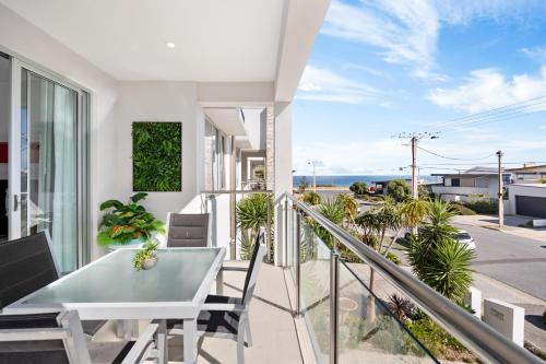 a view from the balcony of a house with a table and chairs at Parea on Cavendish - Luxe Beachside Living in West Beach
