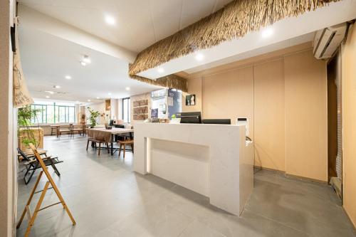 Una oficina con un mostrador blanco y un comedor. en Dengba Inn - Guilin Road Subway Station Branch, en Shanghái