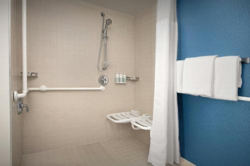 a bathroom with a shower and a toilet with towels at Residence Inn Seattle Bellevue Downtown in Bellevue