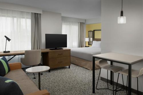 a hotel room with a bed and a television at Residence Inn Seattle Bellevue Downtown in Bellevue